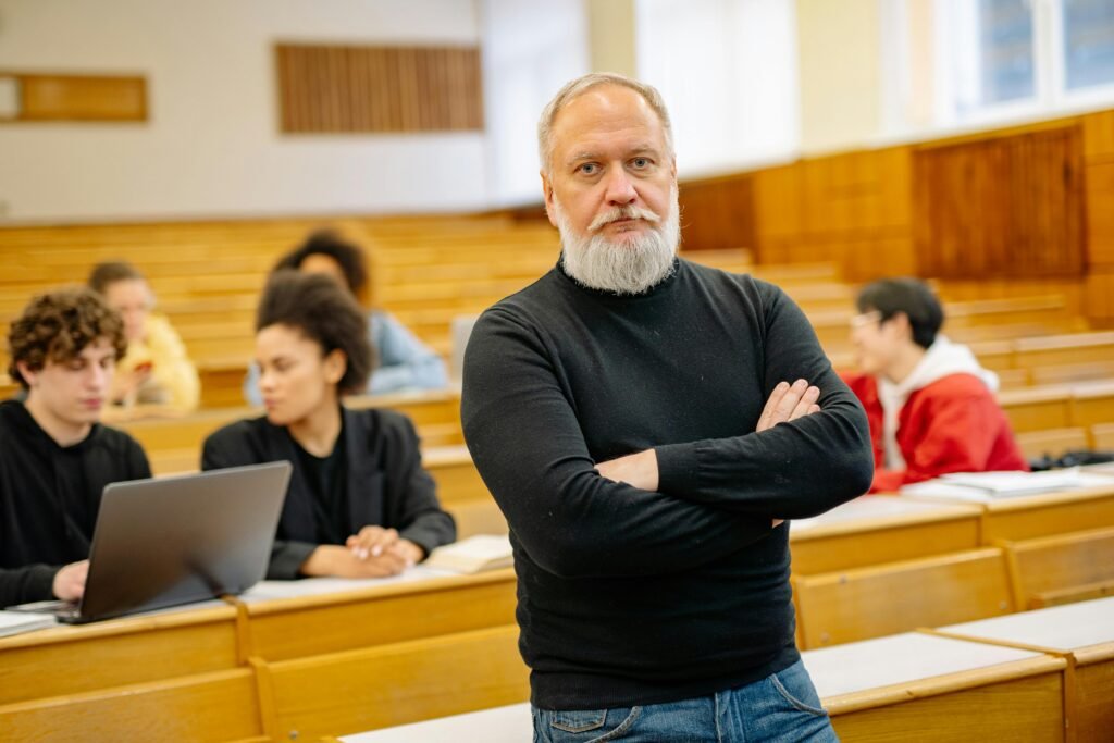 Confident professor in lecture hall with diverse students engaged in learning.